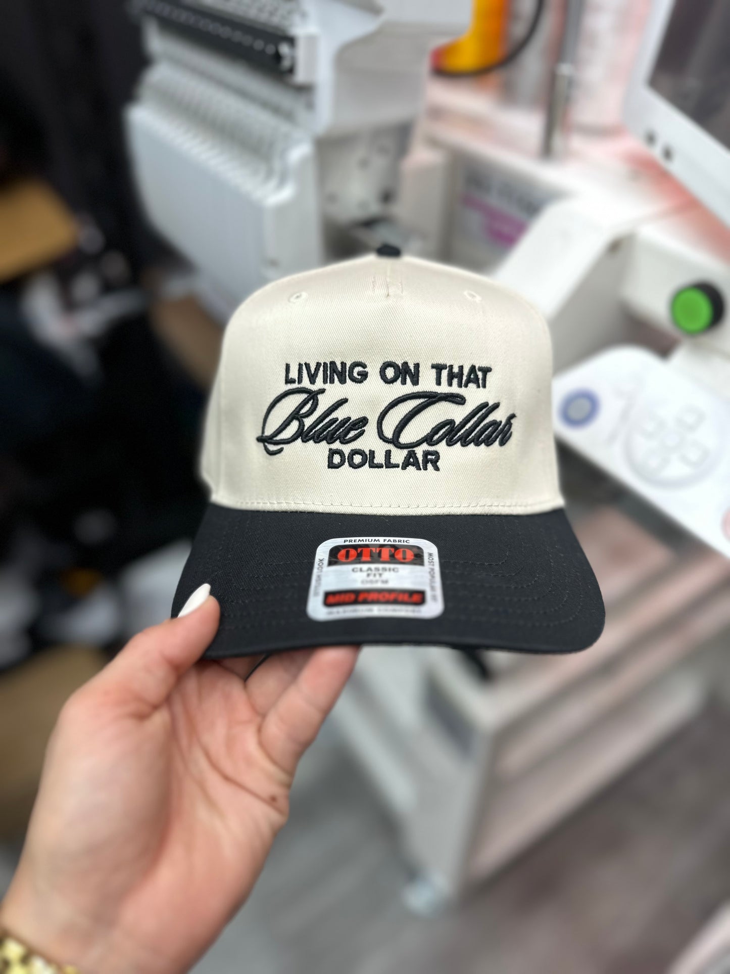 Living on that Blue Collar dollar embroidered trucker hat