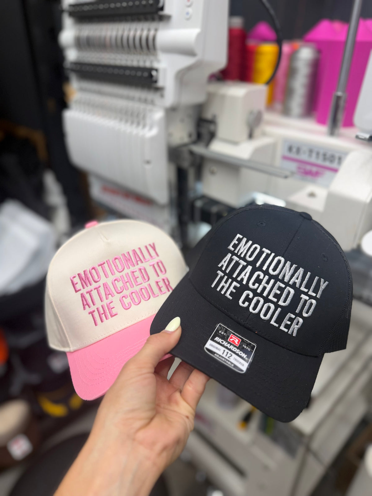 a hand holding a pair of hats