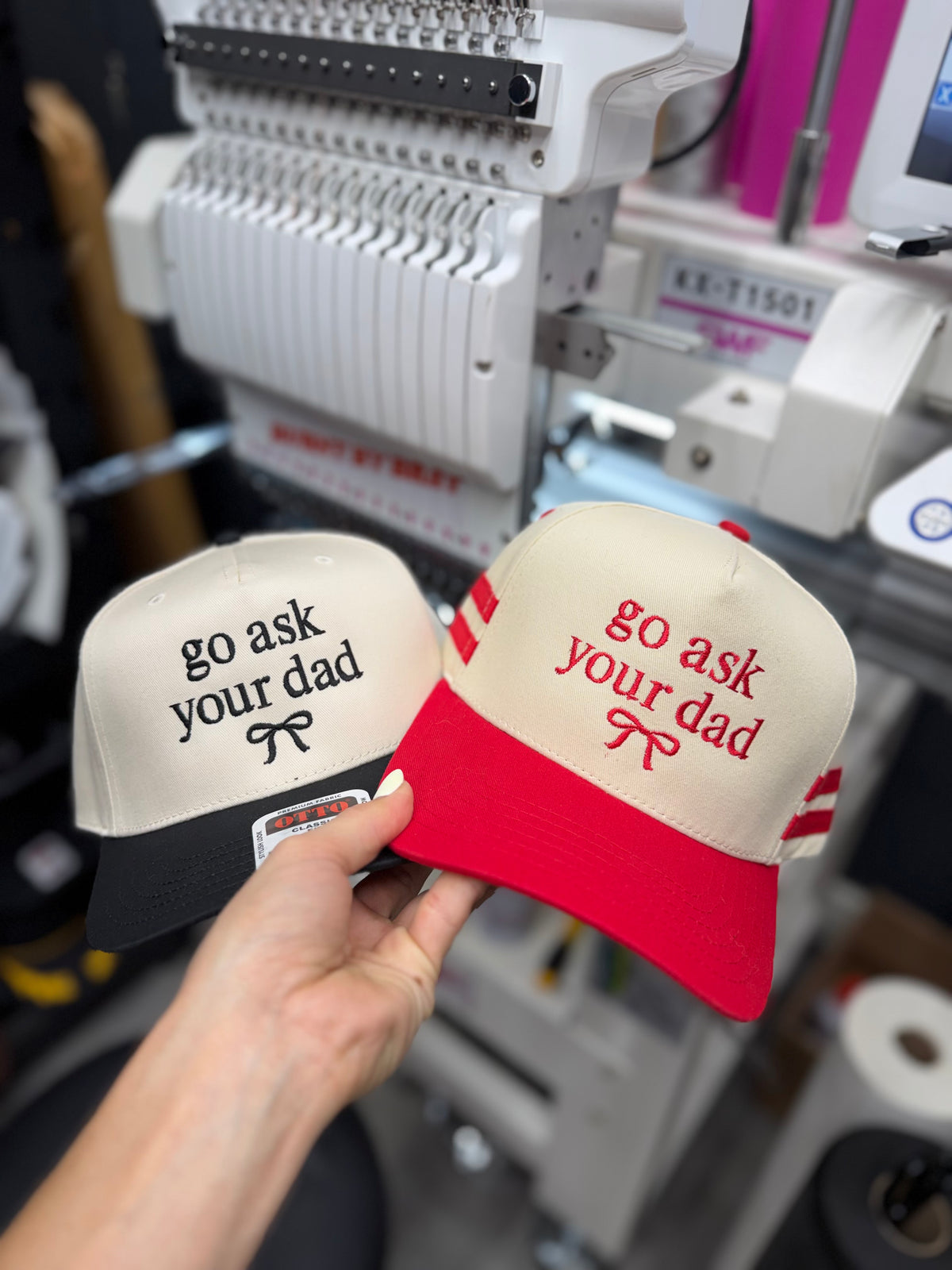 a hand holding a pair of hats