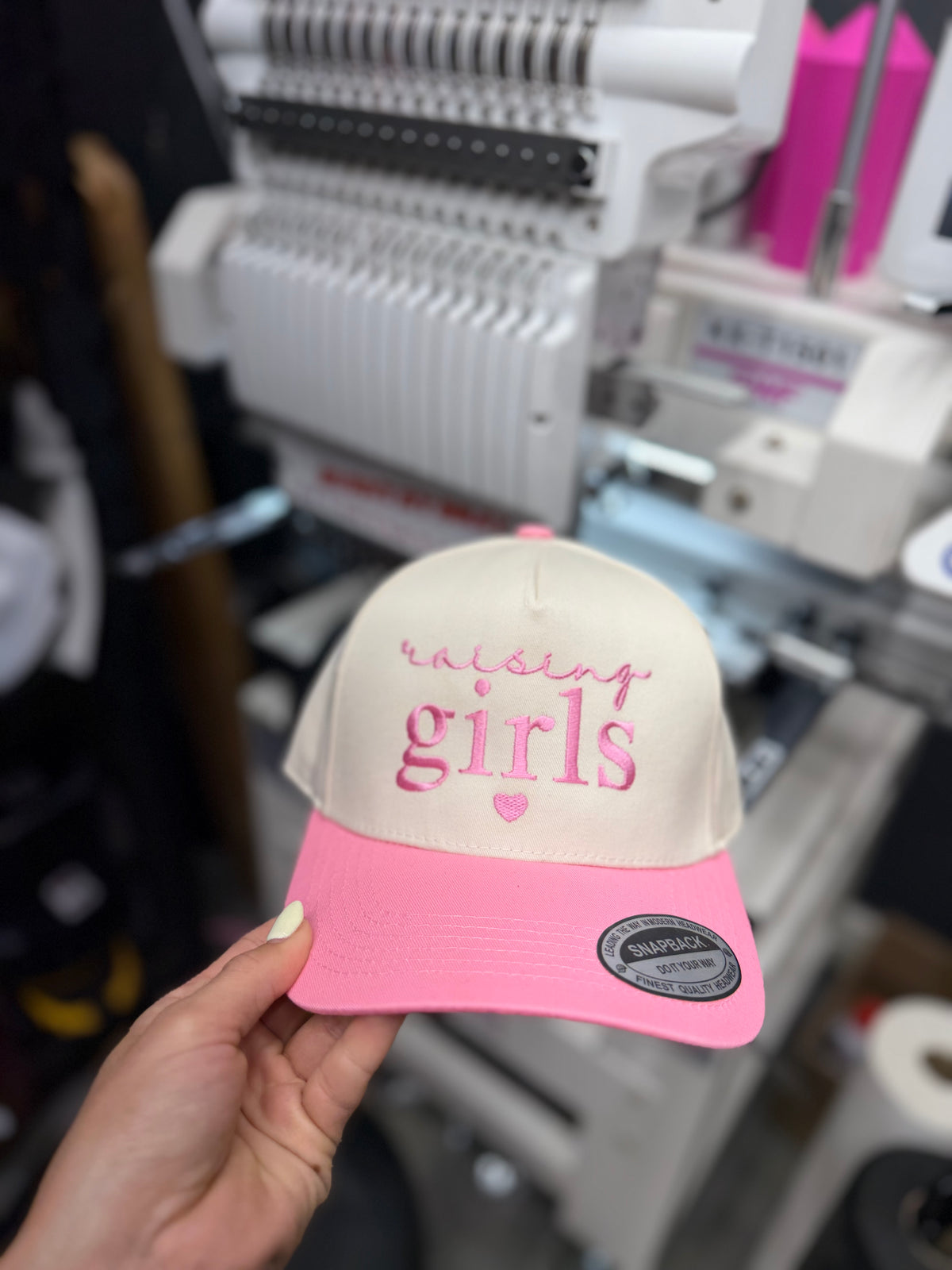 a hand holding a hat