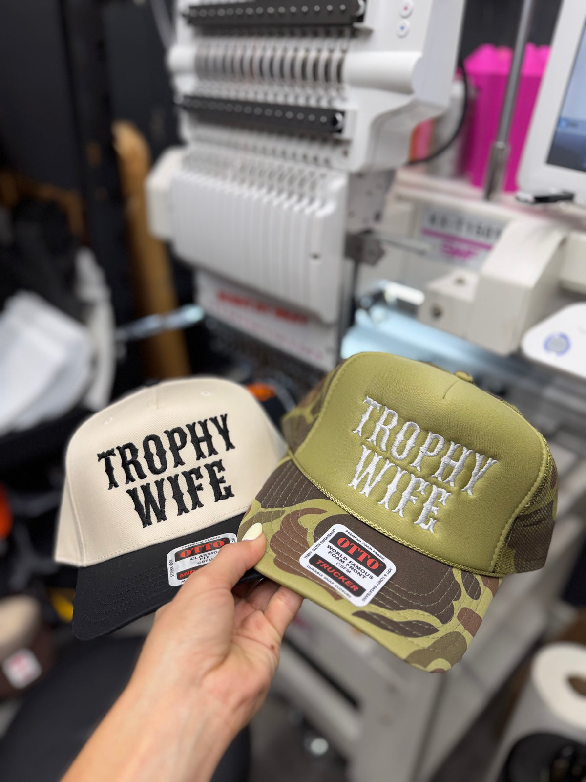 a hand holding two hats