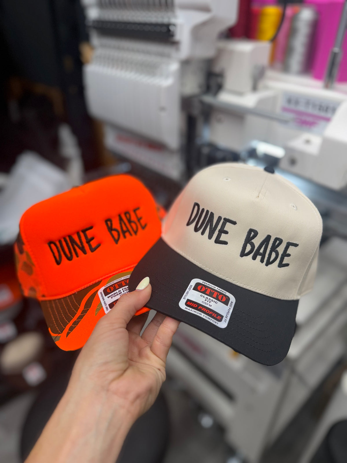 a hand holding a pair of hats