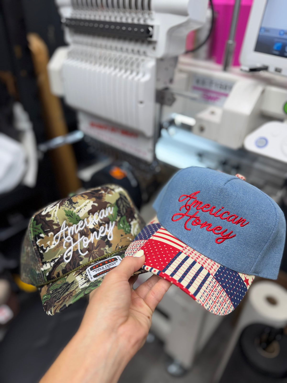 a hand holding a pair of hats