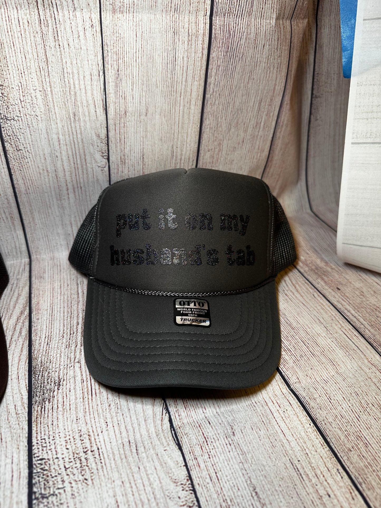 Put it on my husband's tab vinyl trucker hat