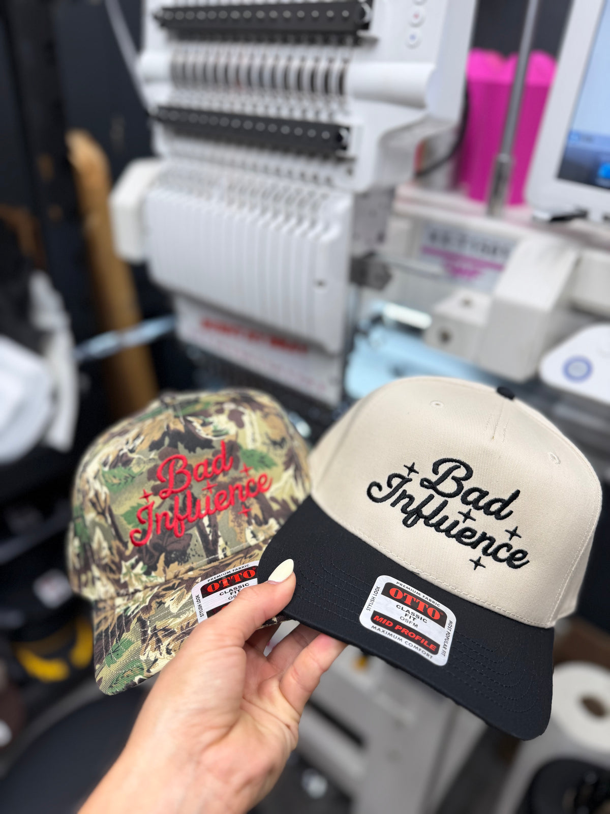 a pair of hats in front of a machine